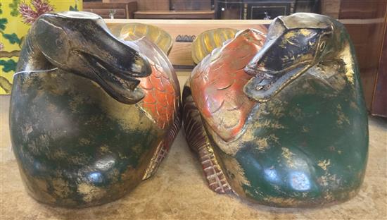 Pair of South East Asian polychrome and gilt decorated wood figures of recumbent ducks(-)